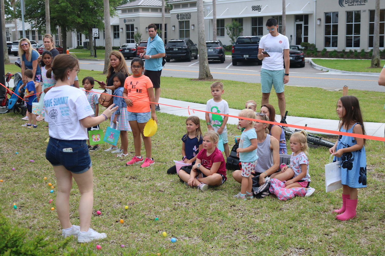 Children listen to instructions prior to the start of the Easter egg hunt.